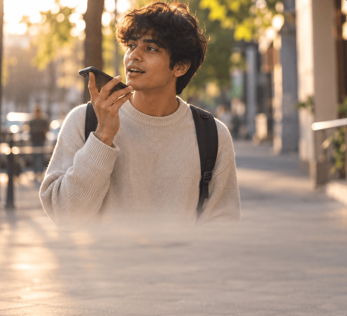 Person recording voice note in golden hour light